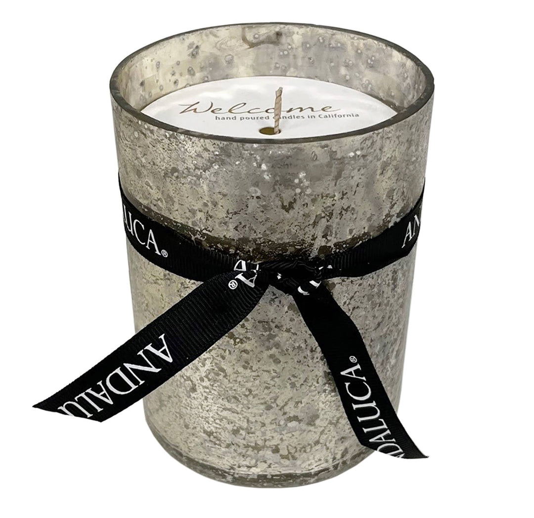 Candle in a textured glass holder with a black ribbon and 'Andaluca' branding on a white background.