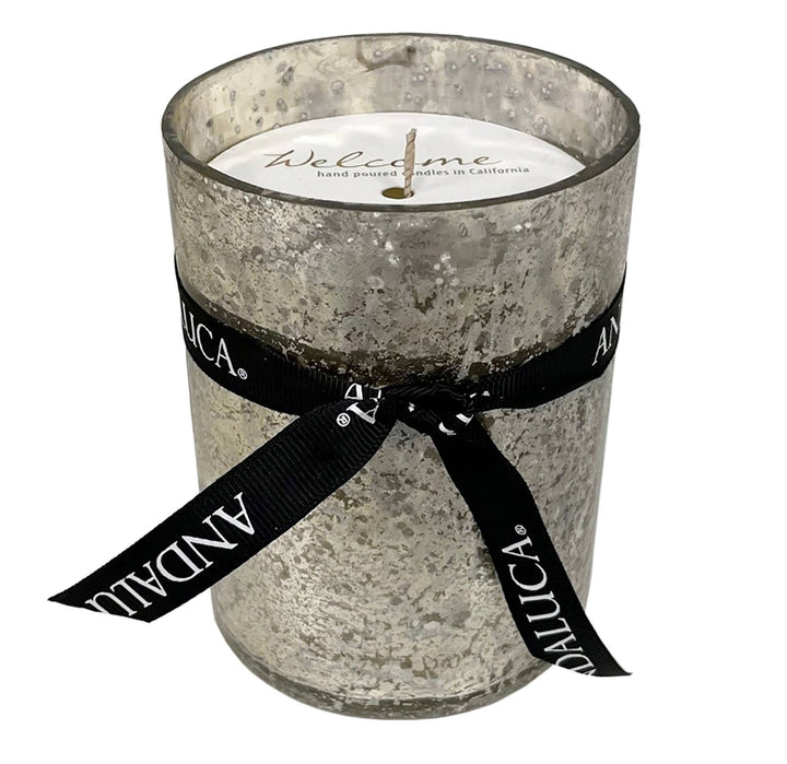 Candle in a textured glass holder with a black ribbon and &