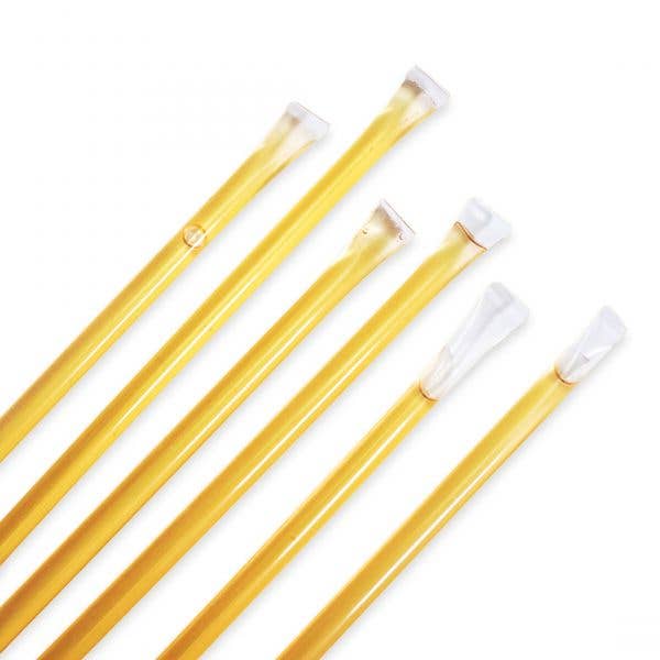 Set of yellow honey straws with white tips on a white background