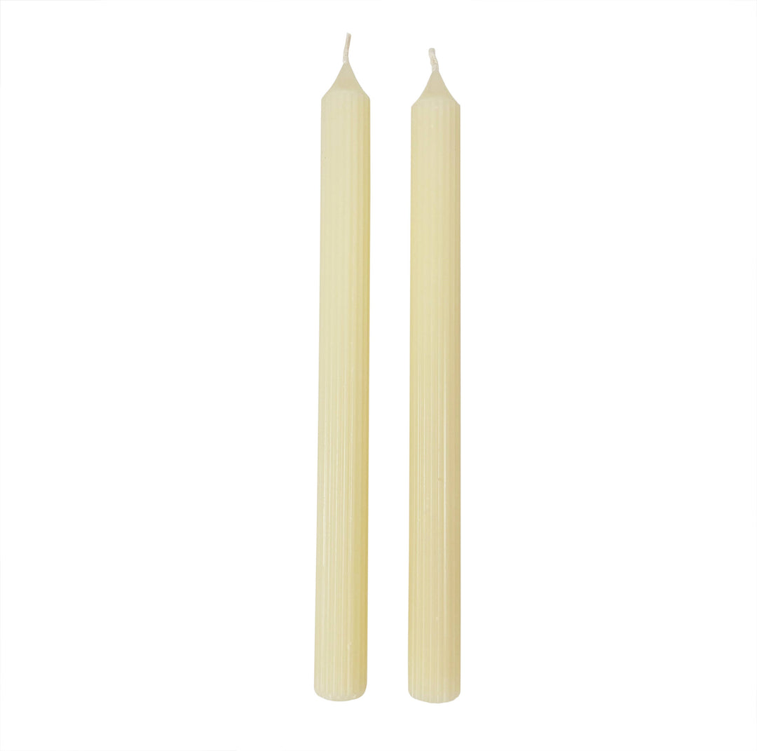 Two beige candles on a white background