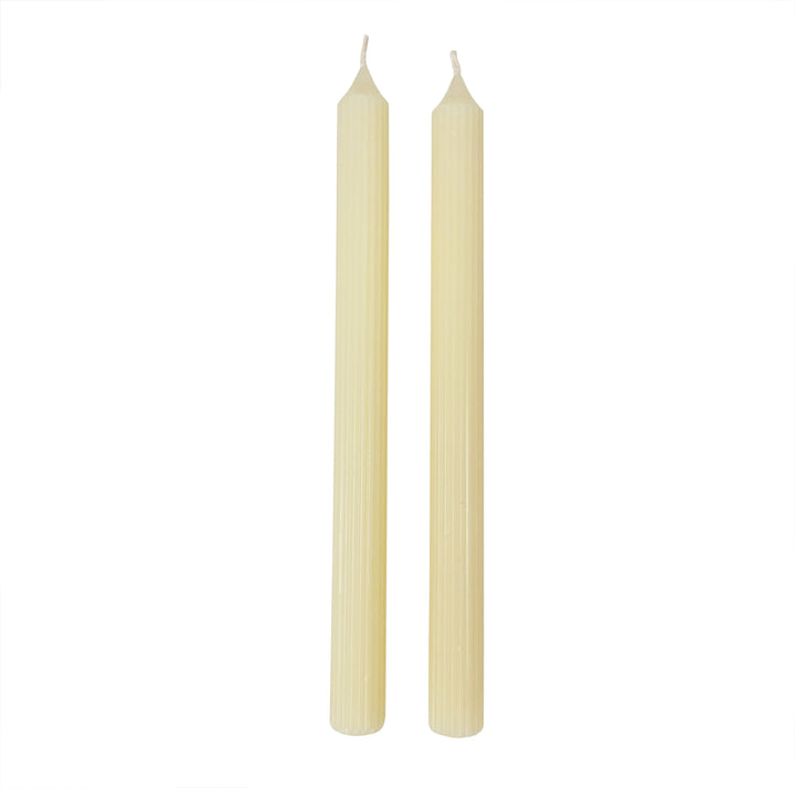 Two beige candles on a white background