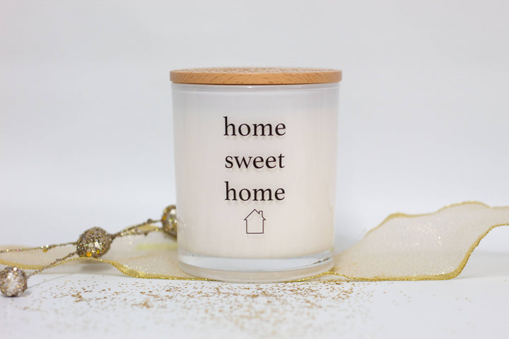 A white soy wax candle with the text &