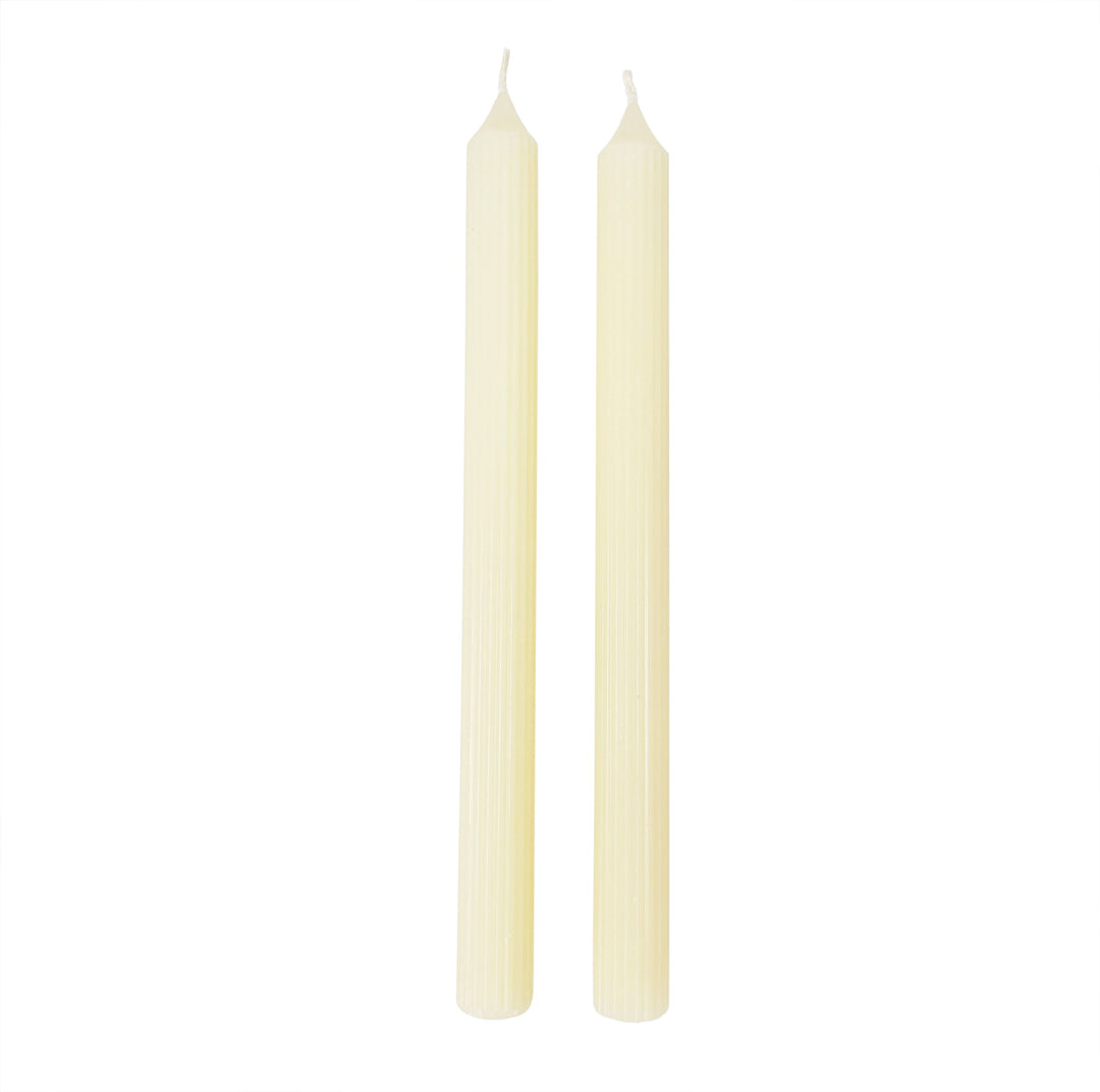 Two beige candles on a white background