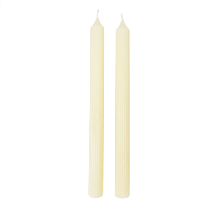 Two beige candles on a white background