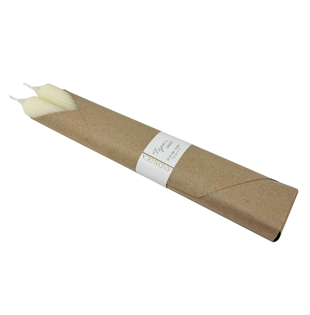Roll of kraft paper with white candle inside on white background