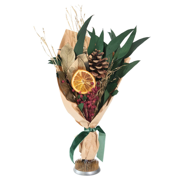 Bouquet of dried flowers with green leaves, pine cones, and orange slices on a white background