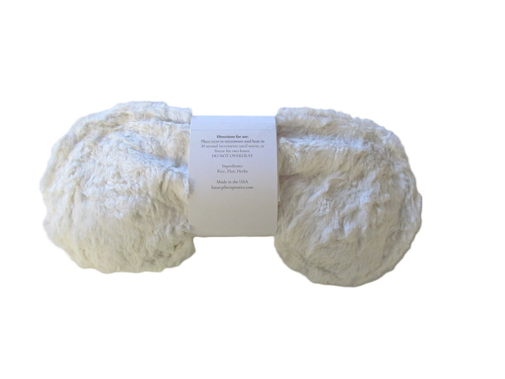 White fur eye pillow with written directions for use on label