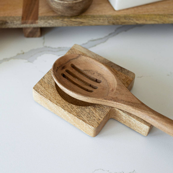 Wooden spoon and dish on a marble surface