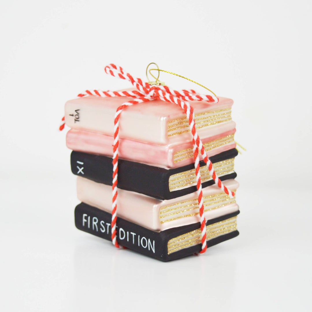 Ornament of decorative books tied with red and white string on a white background