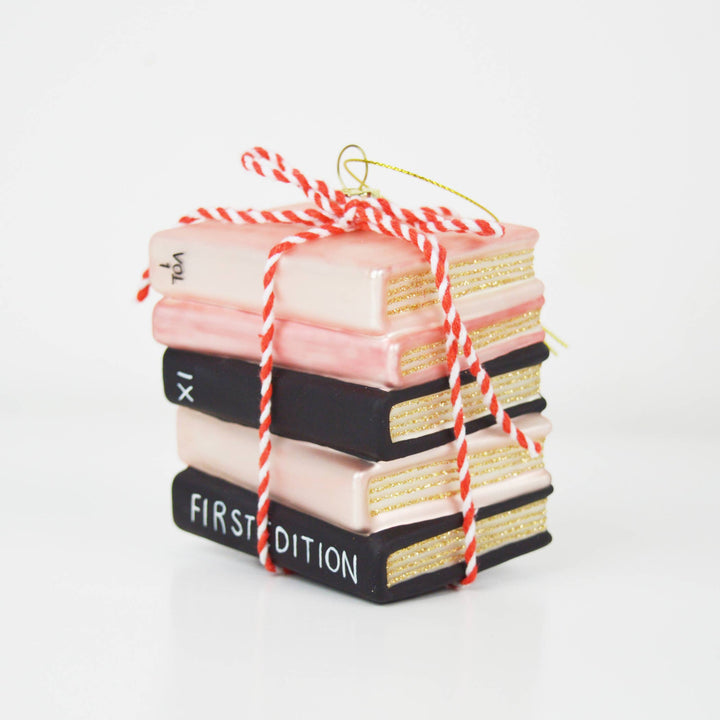 Ornament of decorative books tied with red and white string on a white background