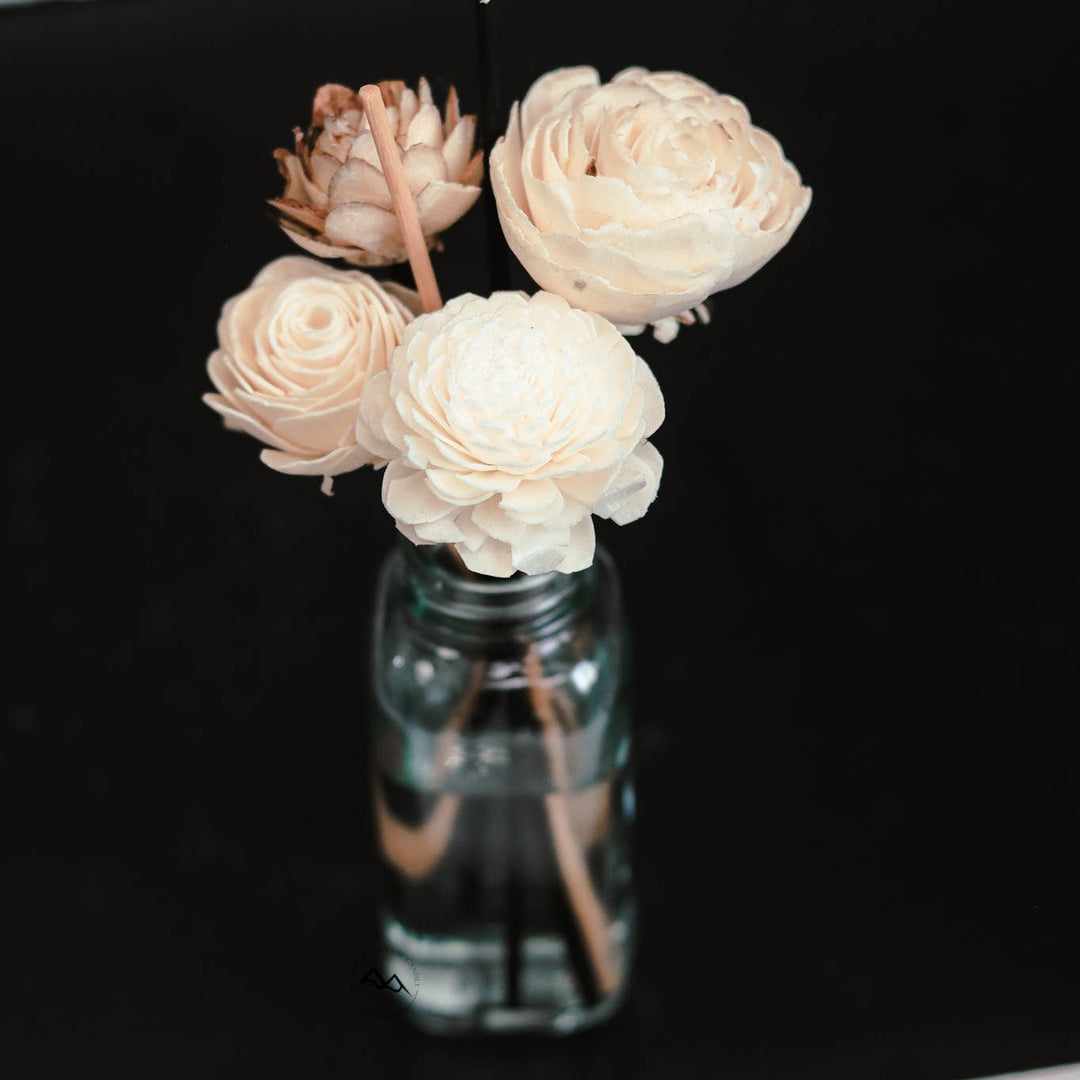 Vase with white flowers on a black background