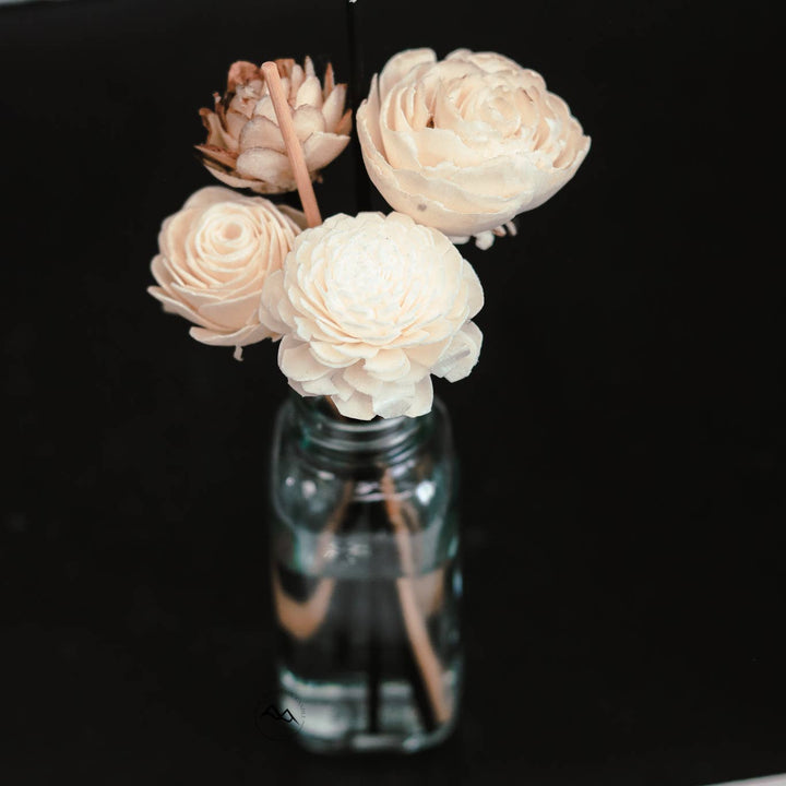 Vase with white flowers on a black background