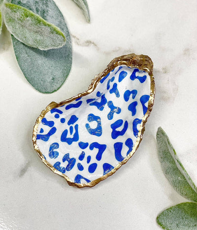 The decoupage oyster trinket dish makes a perfect catchall for your jewelry or a decor piece around your home.  Each trinket dish is handcrafted with care. The edge is trimmed in gold leaf paint with the back left natural.   The shells measure approximately 3-4+ inches in length. As these shells were created by nature, they will vary in shape and size. There will be slight variations in print with each oyster.