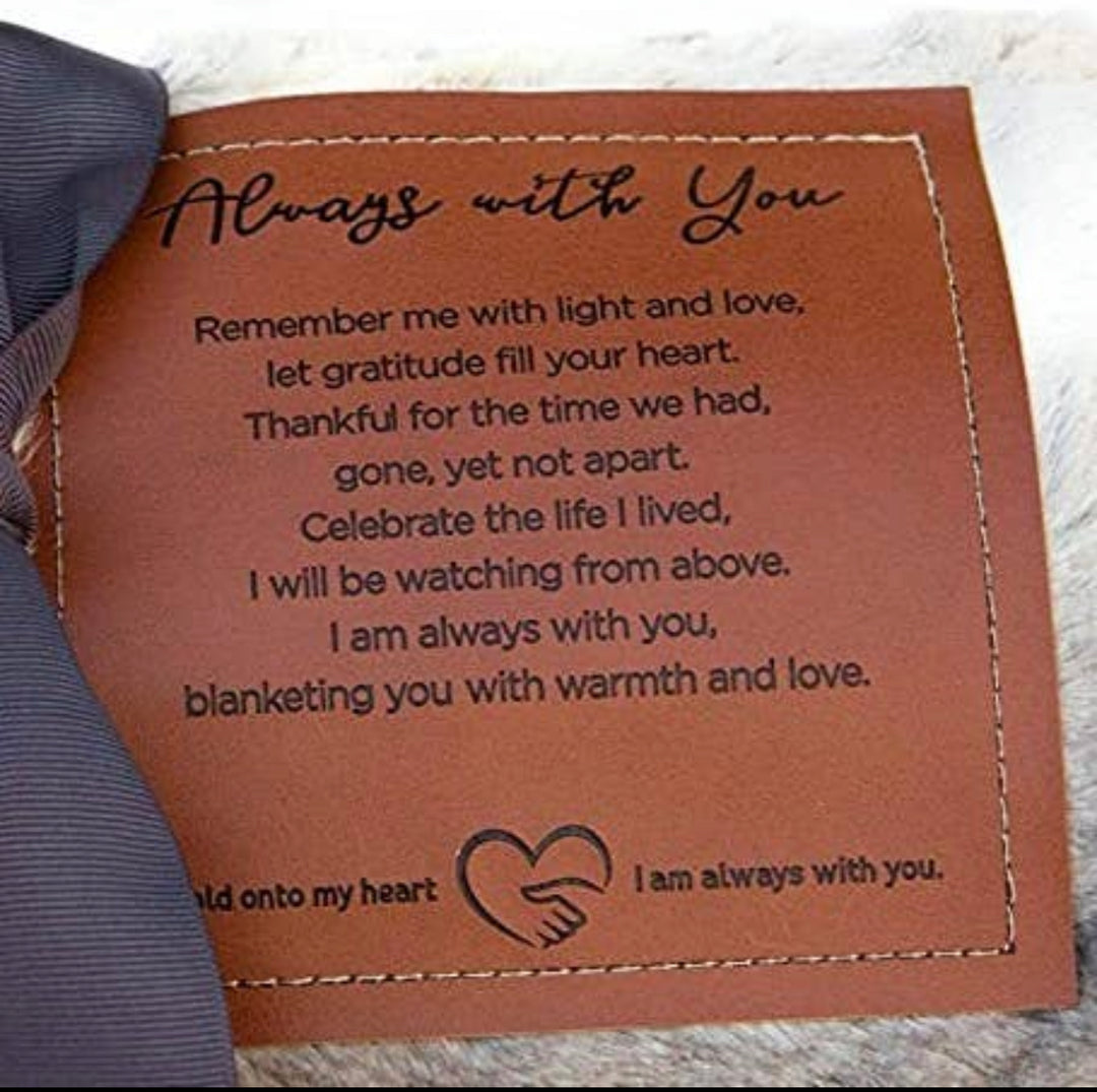 Our "Softly Said" Always with You, comforting blanket measures 50"x65" and is overflowing with warmth and comfort. The faux fur and micro mink gray-toned blanket is an absolute gift for mind, body, and soul. A loving message is embossed on a faux leather label and sewn on the blanket for the recipient to remember your message each time it is used.