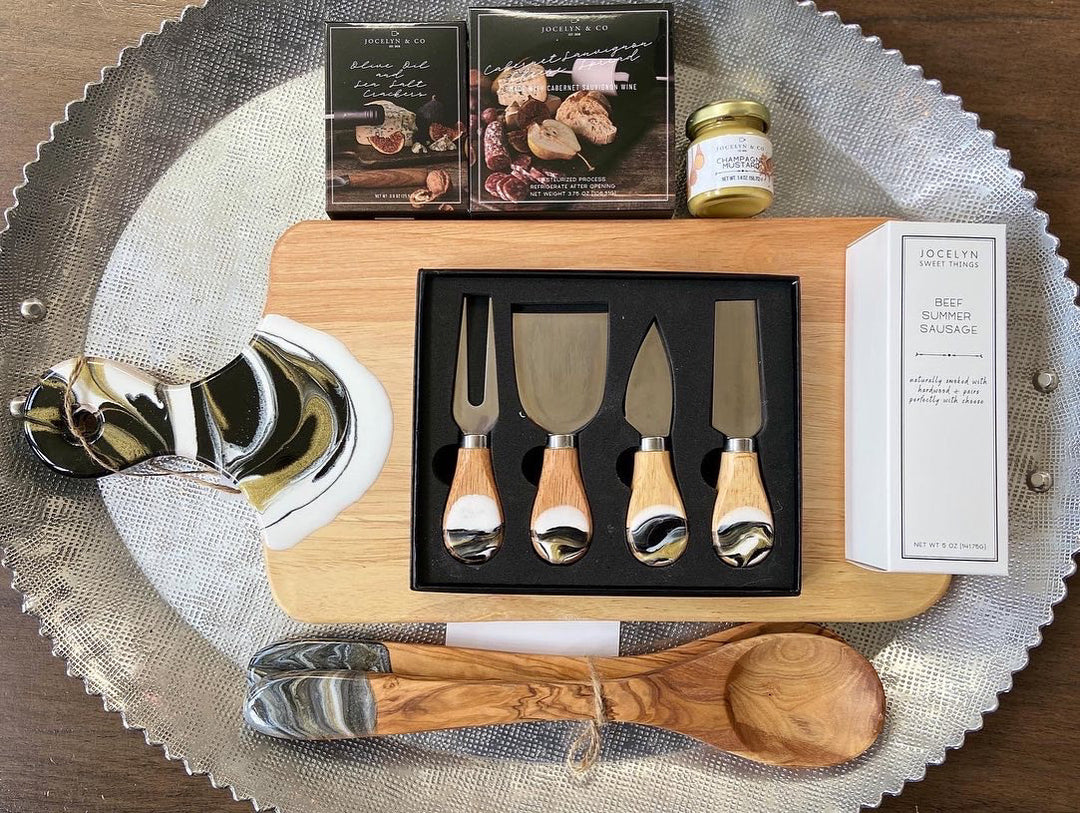 4 wood cheese utensils set in a beautiful black gift box. Each piece is one of a kind organically pour with black, white and gold dripped sides.